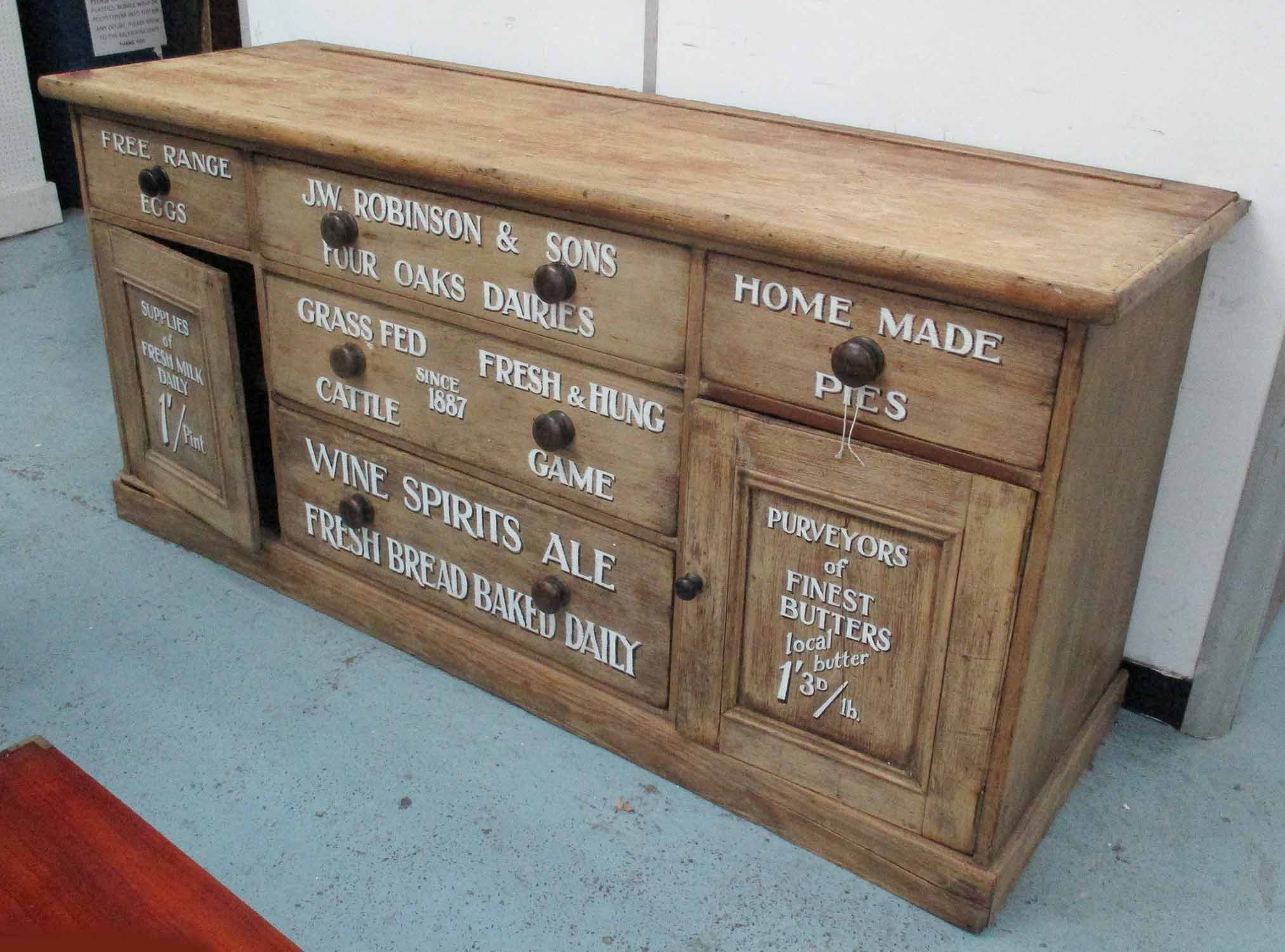 SIDEBOARD, Victorian pine, with drawers and cupboard doors later decorated with shop signage,