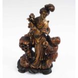 SOAPSTONE FIGURAL GROUP, woman and child, carved wooden stand, 22cm overall.