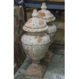 GARDEN URNS, a pair, distress painted terracotta with covers, 82cm H.