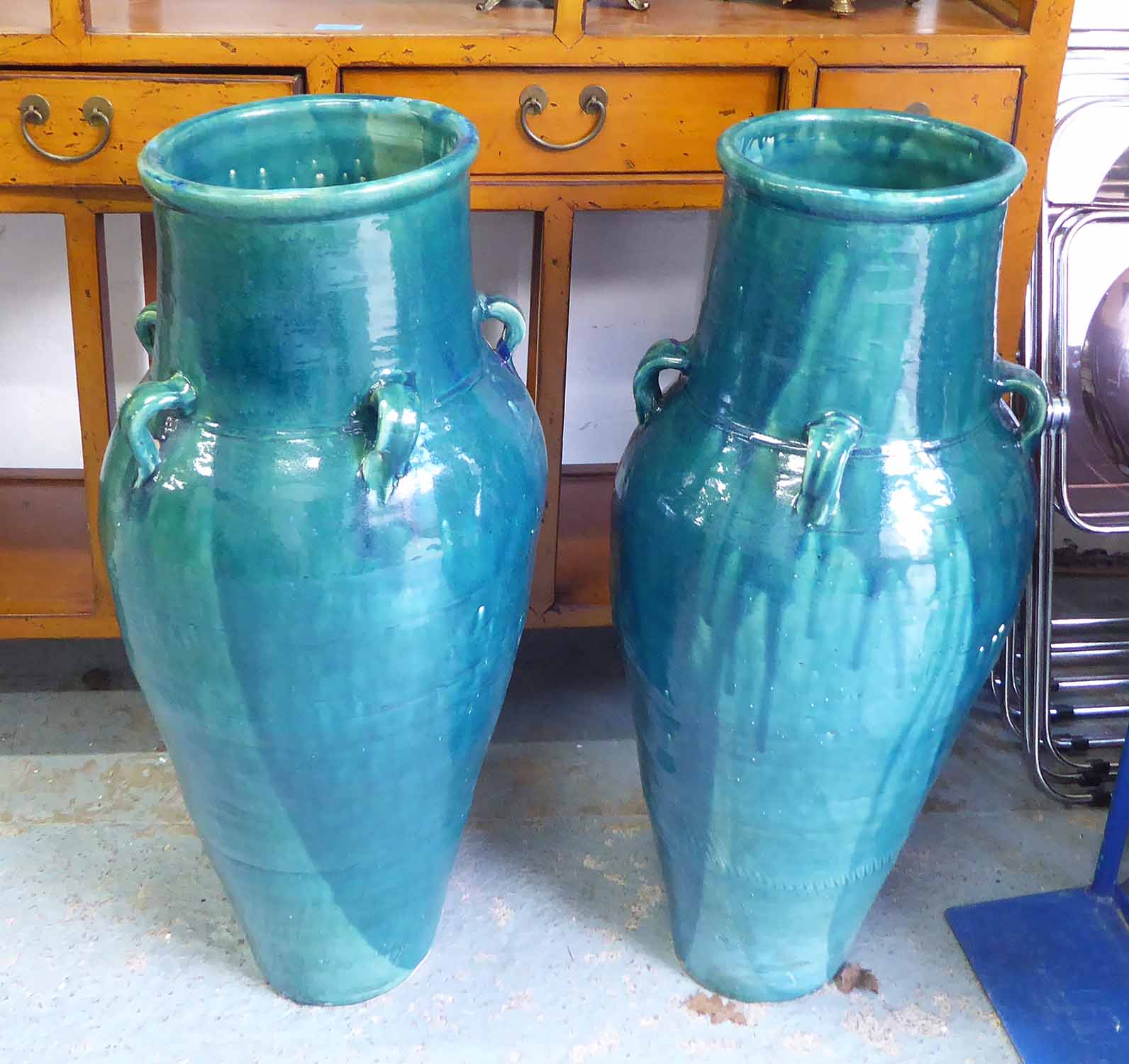 PERSIAN WINE VESSELS, a pair, in a turquoise glaze, 92cm H.