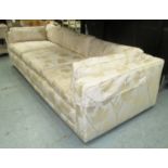 ANDREW MARTIN SOFA, three seater, in cream floral fabric on castors, 229cm L (with faults,