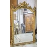 WALL MIRROR, late 19th century French giltwood and gesso with arched plate in a dove, torch,