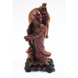 SOAPSTONE FIGURE, man with foo dog, carved wooden stand,