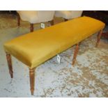LONG STOOL, with gold velvet upholstery on reeded turned supports, 152cm L x 48cm H x 40cm D.