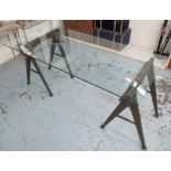 INDUSTRIAL STYLE DINING TABLE, the glass top on wood and metal painted trestles,