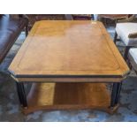 LOW TABLE, of substantial proportions, satinwood on ebonised pillars with canted corners,