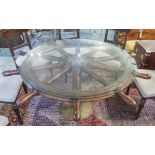 SHIP'S WHEEL TABLE, teak with circular glass top on brass column, 72cm H x 152cm D.