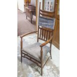 ARMCHAIR, Arts and Crafts mahogany circa 1910 in Liberty manner with faded grey upholstery,