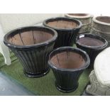 PLANTERS, two pairs, glazed fluted in black, large 57cm H, small 46cm H.
