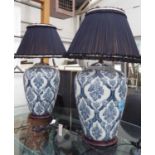 LAMPS, a pair, Chinese vase form in blue and white with navy blue pleated shades, 90cm H.