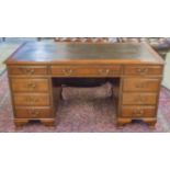 PEDESTAL DESK, early 20th century with black leatherette top above nine drawers,