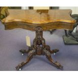 CARD TABLE, Victorian figured walnut, the serpentine top raised upon a carved quadruped base,