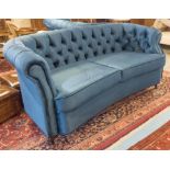 SOFA, in button back blue velvet with concave seat and cabriole supports, 195cm x 92cm x 94cm H.