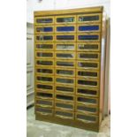 HABERDASHERY CABINET, early 20th century vintage oak with thirty six glass fronted drawers,