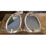 WALL MIRRORS, a pair, 19th century Continental with oval silvered wood frames, 70cm H x 46cm.