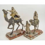ARABIAN STYLE BEDOUIN AND CAMELS, a pair, silvered and gilt bronze, 41cm H.