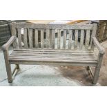 GARDEN BENCH, silver weathered teak and slatted with shaped back by Alexander Rose, 148cm W.