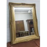 WALL MIRROR, the gilt frame with a bevelled plate, 75cm x 102cm.