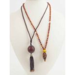 CHINESE AMBER PENDANT NECKLACE, and Chinese carved lacquer pendant on silk braide.