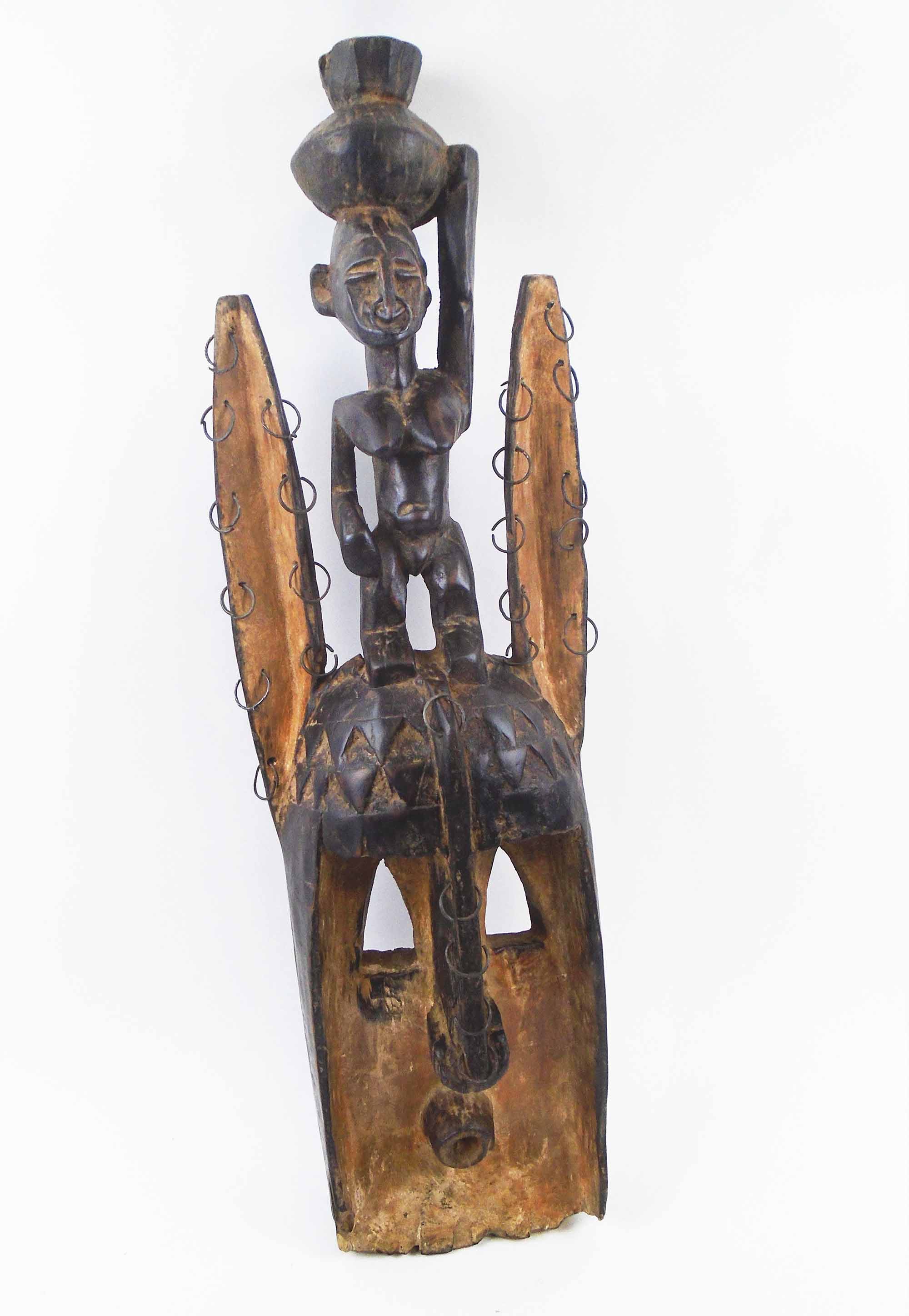 DOGON FACE MASK, Mali, carved wood with whitened detail, 70cm H overall.