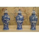 VASES, a set of three, blue and white Chinese ceramic each with 'Dog of foo' lids, 27cm H.