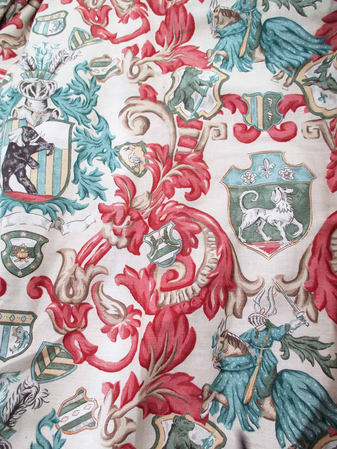 CURTAINS, a pair, heraldic designs on a cream background, lined and interlined,