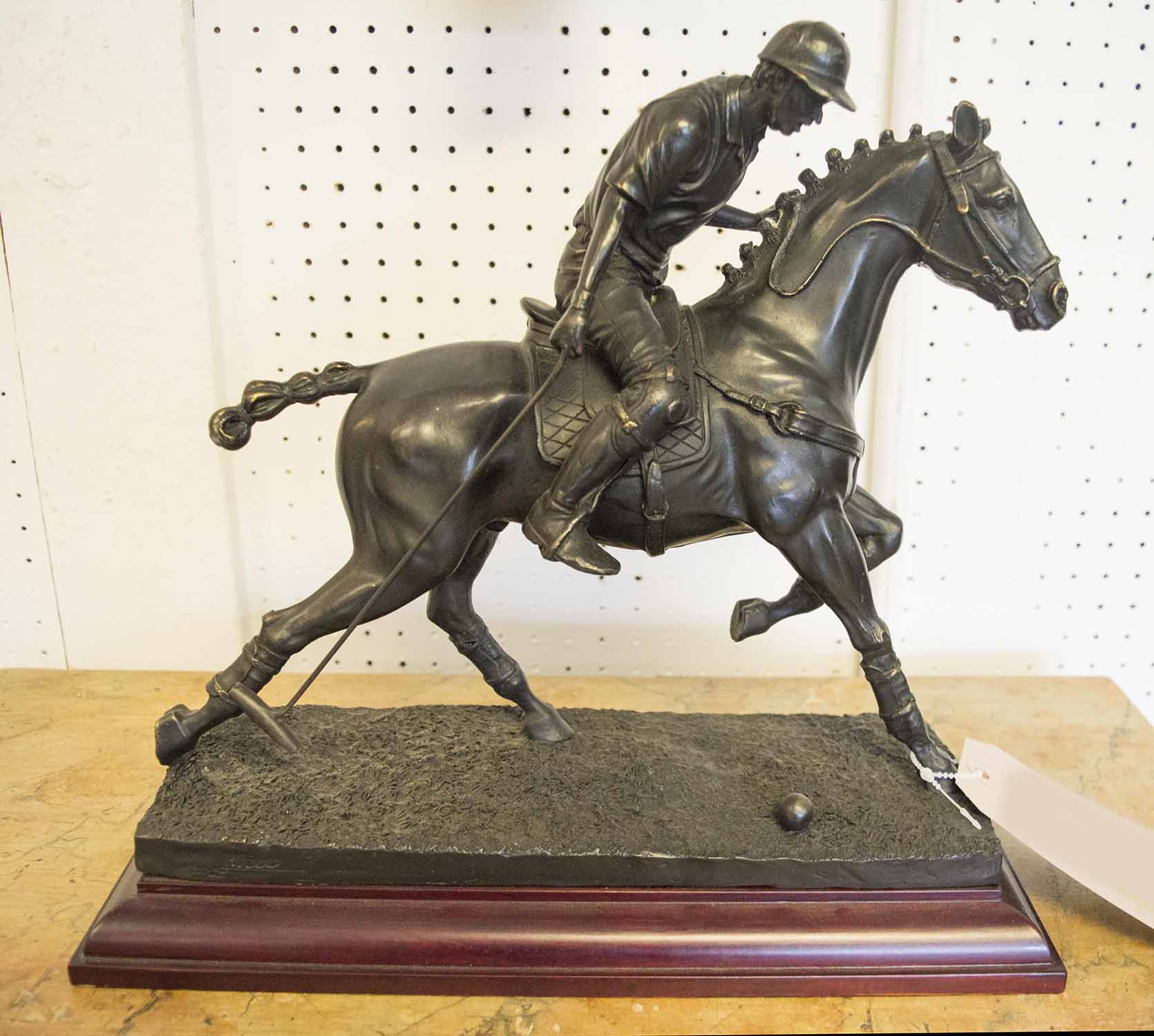 BRONZE FIGURE, contemporary of a Polo player on horseback, 32cm H x 34cm L x 15cm W.