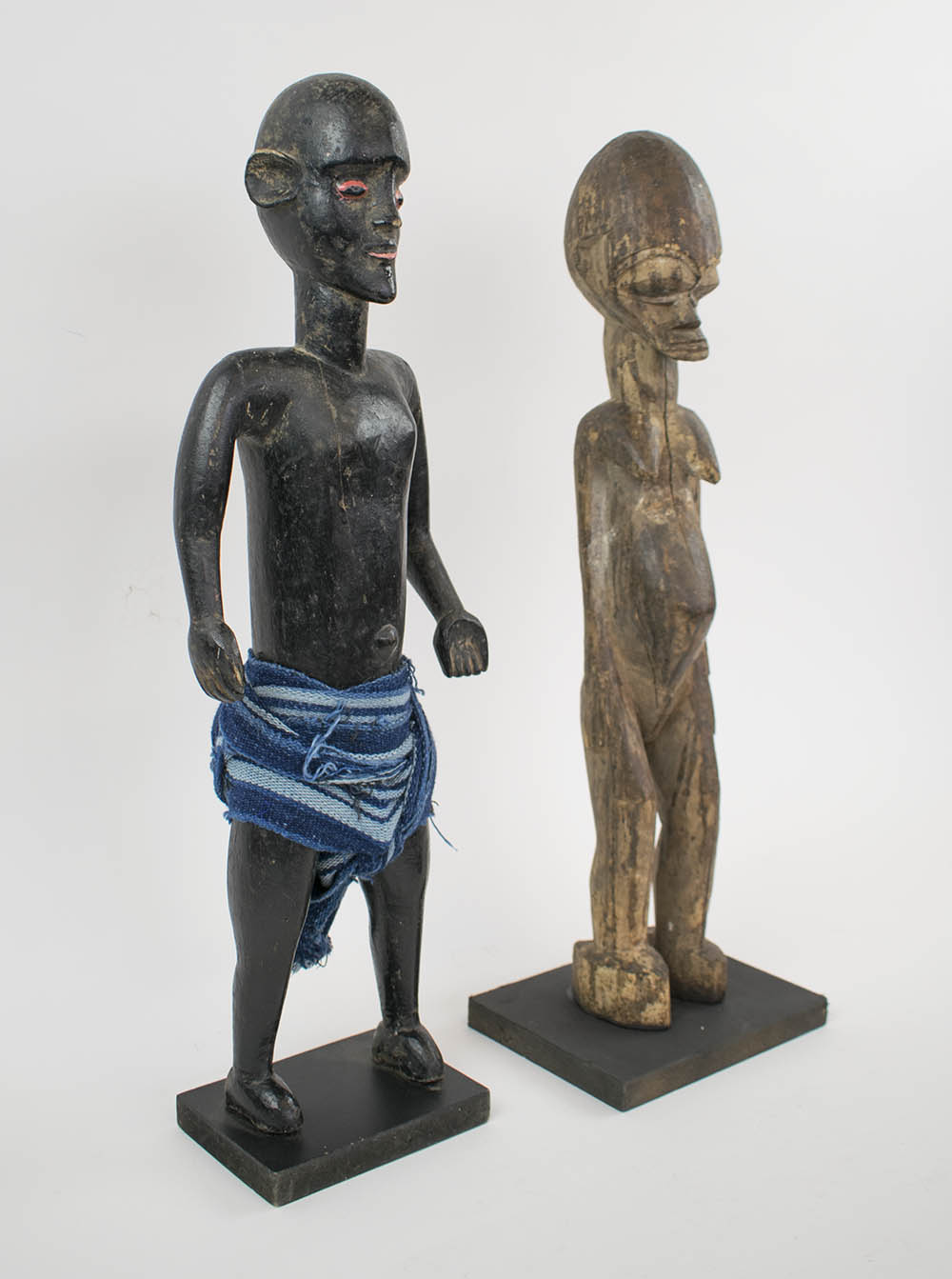 LOBI STANDING FIGURE, 53cm H, and a Mali ebonised guardian figure, 53cm H, both made of carved wood.