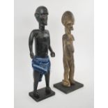 LOBI STANDING FIGURE, 53cm H, and a Mali ebonised guardian figure, 53cm H, both made of carved wood.