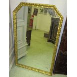WALL MIRROR, 19th century Continental giltwood with leaf decorated canted corner frame,
