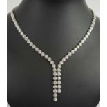 FINE DIAMOND LINE NECKLACE, composed of fifty four uniform size brilliant cut diamonds,