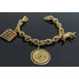 A 1950's YELLOW GOLD BRACELET, with three charms attached, total weight 44.5 grams, 21.5cm Long.