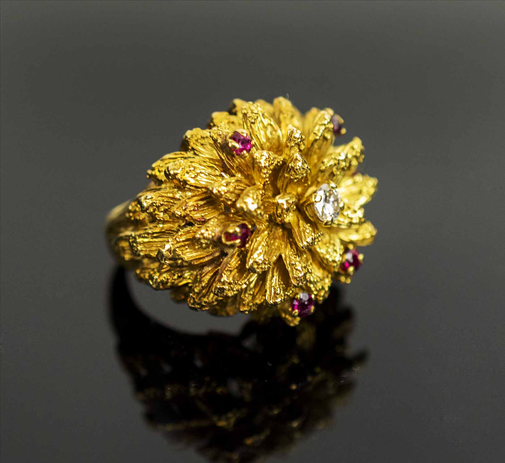 A 1950's RUBY AND DIAMOND SET DRESS RING, of flower design, finger size J, total weight 21.6 grams.