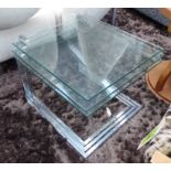NEST OF THREE GLASS TABLES, on polished metal frames, largest 52cm x 57cm x 46cm H.