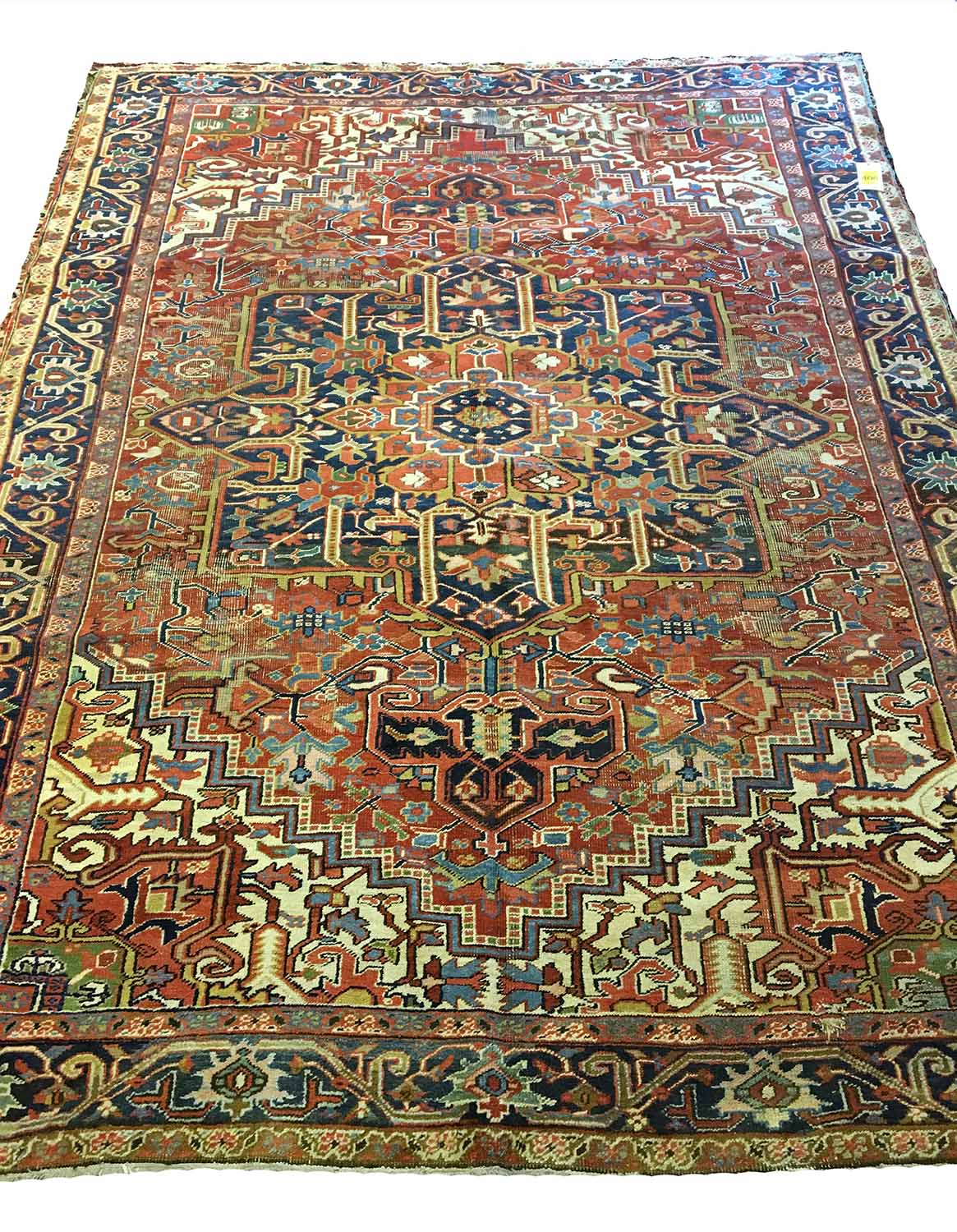 ANTIQUE SERAPI HERIZ CARPET, 335cm x 242cm, sapphire medallion on ruby field.