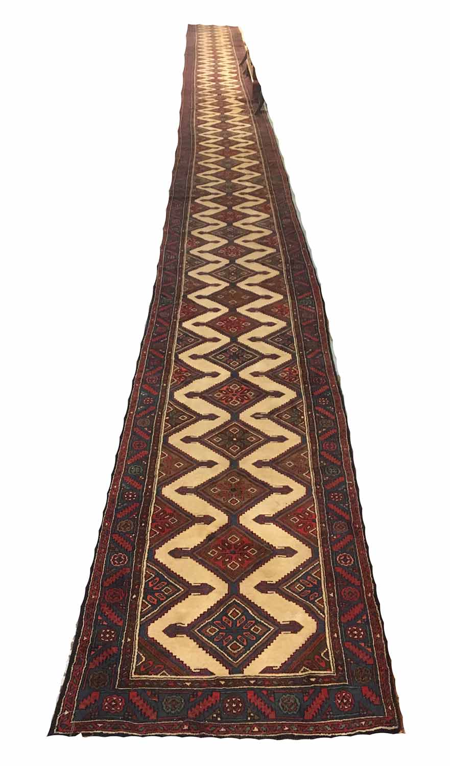 PERSIAN MEHRABAIN RUNNER, 1155cm x 79cm, of multiple diamond medallions on ivory field.