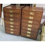 SIDE CHESTS, a pair, each with seven drawers (for cutlery) and campaign handles in veneered finish,