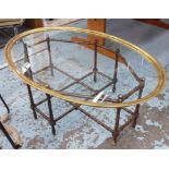 COFFEE TABLE, glass oval top with a brass trim on faux bamboo base, 113cm x 49cm D x 43cm H.