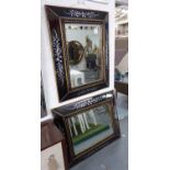 WALL MIRRORS, a pair, the angled verre noire frames enclosing bevelled plates, 98cm x 80cm.