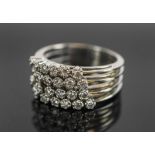 DIAMOND AND 18K WHITE GOLD FOUR ROW DRESS RING.