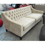 BESPOKE SOFA, two seater, in dark cream button back on ebonised supports, 190cm L.