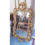 WALL MIRROR, George III design with a pierced and scrolled gilt wood frame, 123cm H x 63cm.