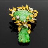 A 1950's JADETTE DIAMOND AND GOLD BROOCH, of naturalistic design, 5.5cms Long, approx weight 23.