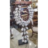 A STRIKING TRIBAL COWRIE SHELL NECKLACE, displayed on a stand, large size, 78cm H on stand.