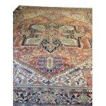 ANTIQUE HERIZ CARPET, 353cm x 290cm of polychrome decoration on ivory and terracotta field.