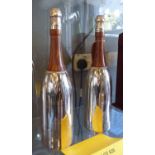 CHAMPAGNE BOTTLE COCKTAIL SHAKERS, a pair, after Suckling & Son, 37cm H.