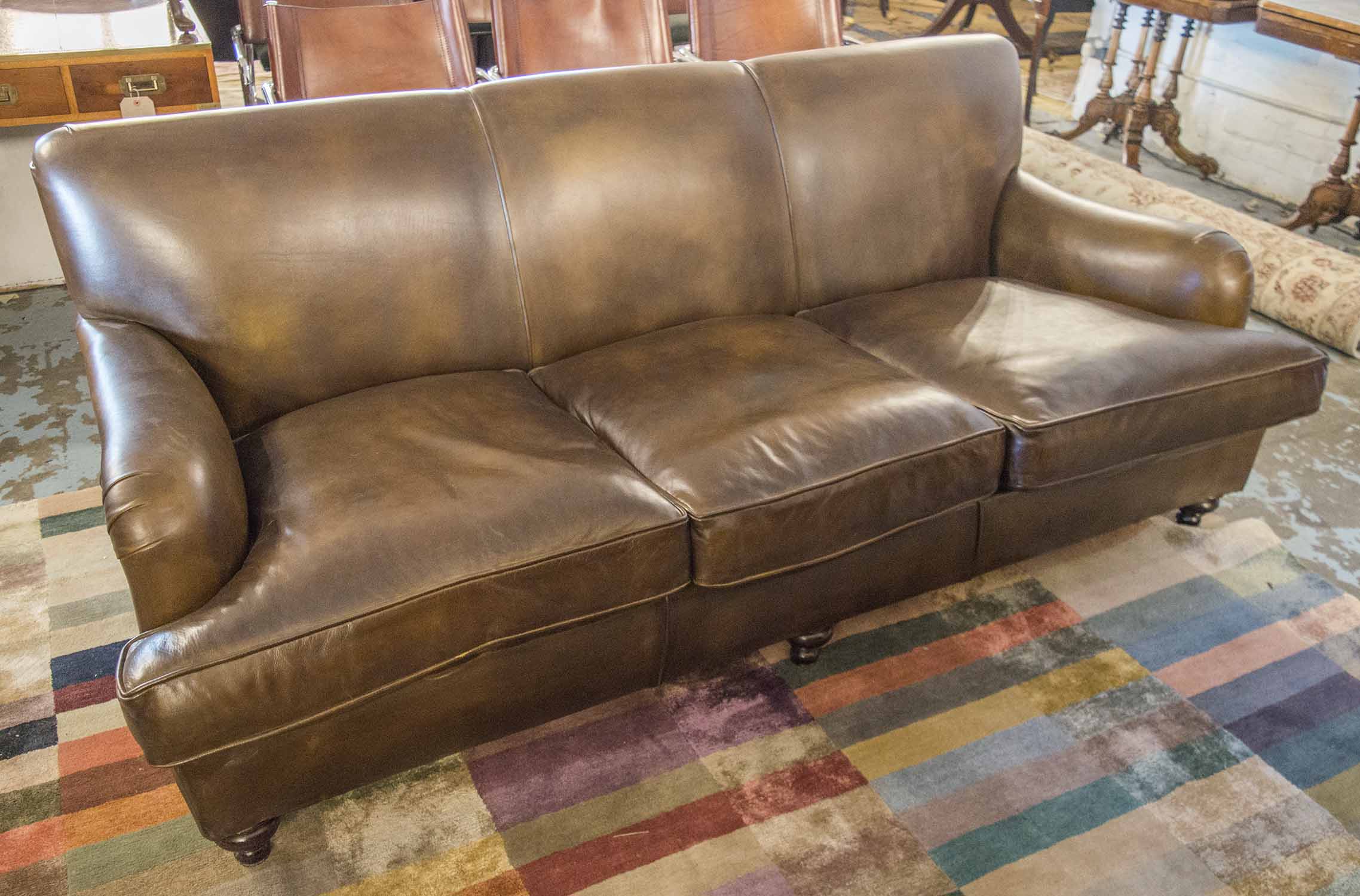 SOFA, brown leather upholstered with three seat cushions, 208cm W.