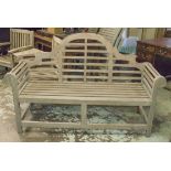 LUTYENS STYLE GARDEN BENCH, weathered teak and slatted after a design by Sir Edwin Lutyens, 166cm W.