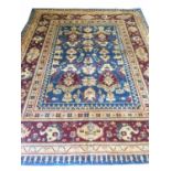 FINE AGRA CARPET, 294cm x 234cm, of stylised palmettes on sapphire field within ruby borders.
