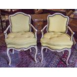 FAUTEILS, a pair, early 20th century French Louis XV style giltwood and painted,